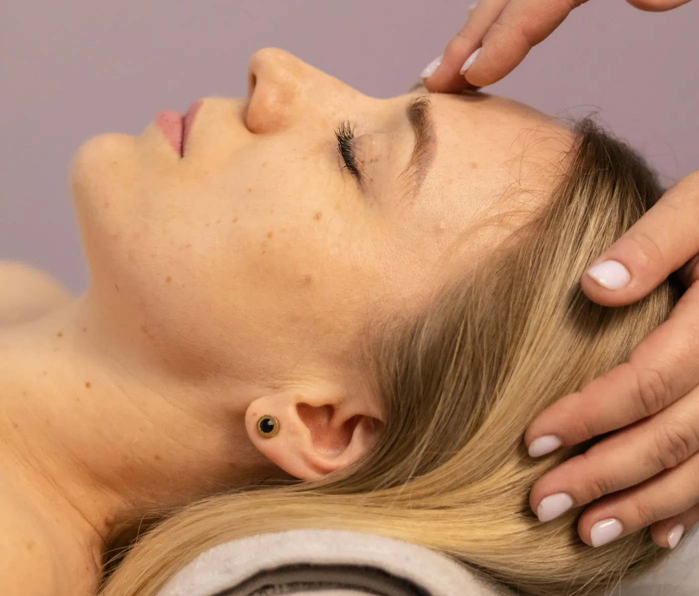 Hands giving a facial treatment