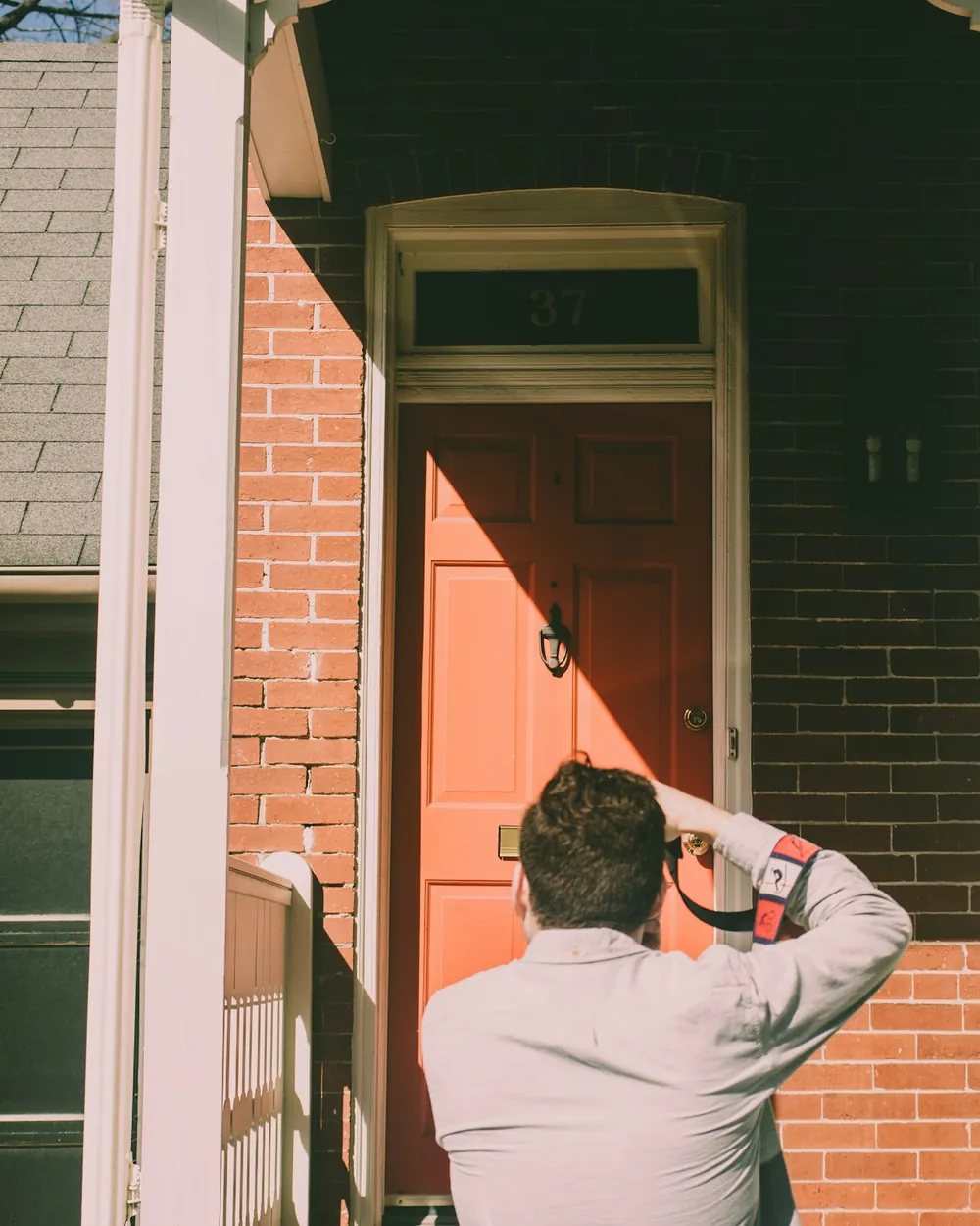 Inspetor fotografando a porta de entrada de uma casa