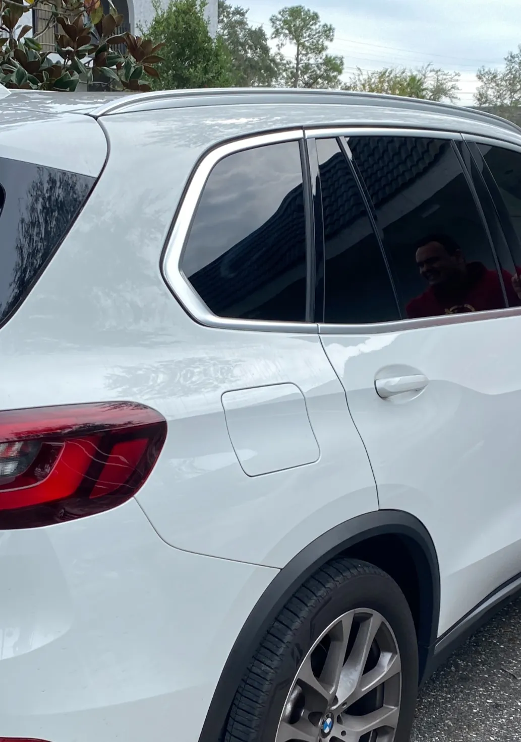 White BMW SUV with tinted rear windows