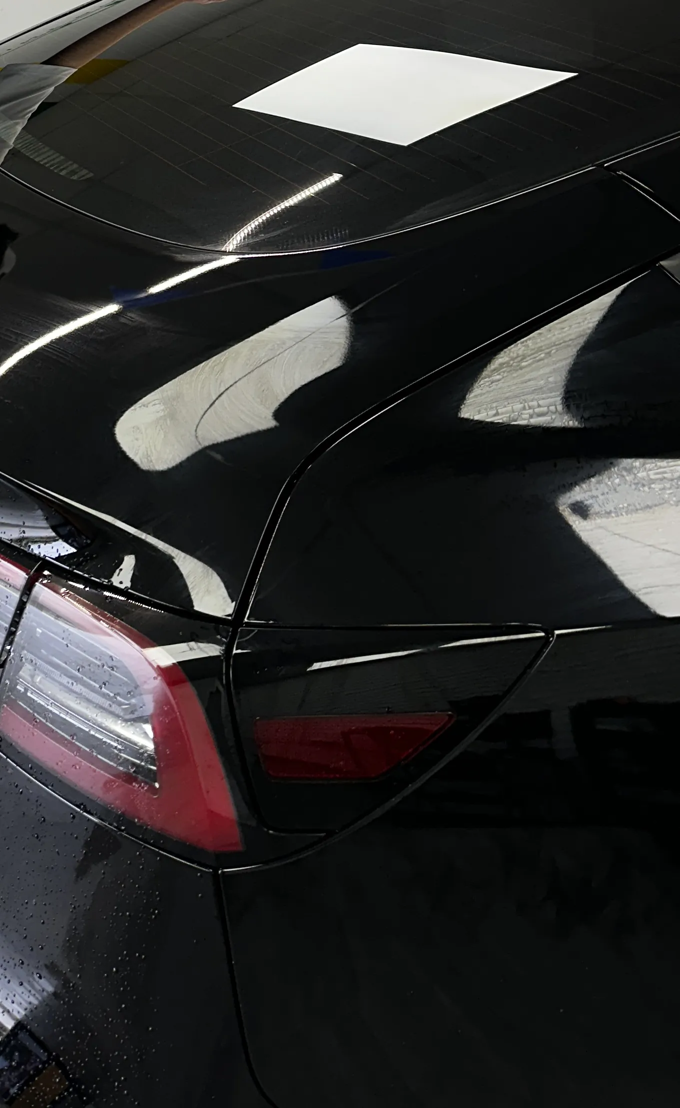 Rear of a black Tesla with tinted glass